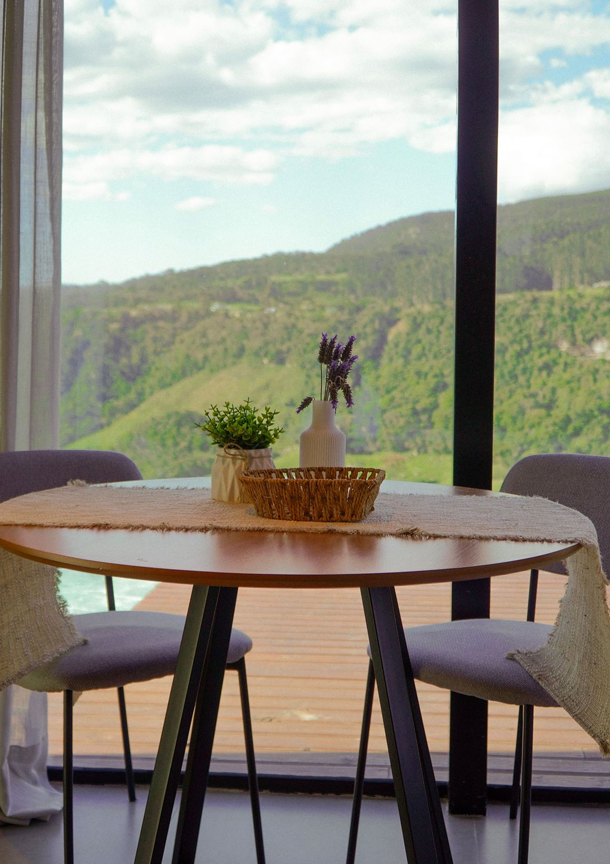 Mesa de jantar diante da janela com vista para o vale